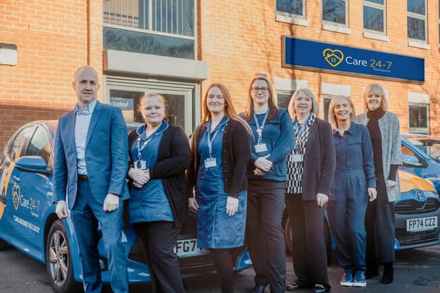Some of the Care 24-7 Team with the new car fleet outside the Leeds office