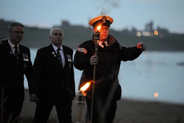 TS Collingwood Sea Cadets carry the flame to be handed to veteran Joe Smith Bailes to light the first of two beacons in South Shields.