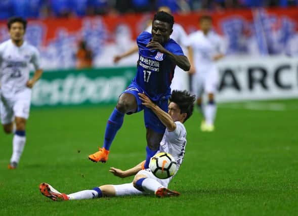 Lee Jong Sung (R) of Suwon Samsung Bluewings fights for the ball with Obafemi Martins of Shanghai Shenhua during the AFC Champions League group stage football match between China's Shanghai Shenhua and South Korea's Suwon Samsung Bluewings in Shanghai on March 13, 2018. / AFP PHOTO / - / China OUT        (Photo credit should read -/AFP via Getty Images)