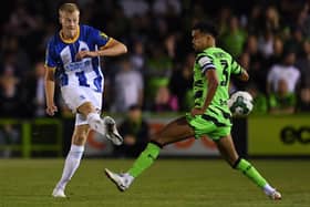 Jan Paul van Hecke of Brighton & Hove Albion passes the ball under pressure. (Photo by Alex Burstow/Getty Images).