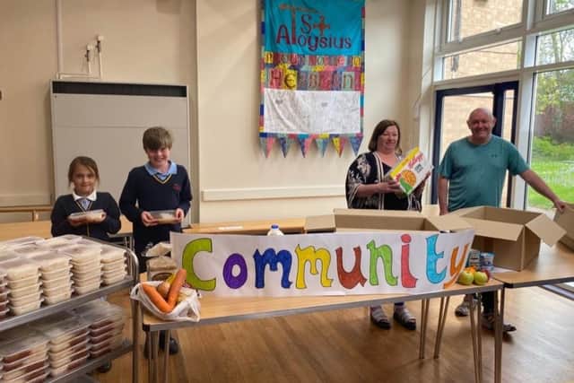 St Aloysius pupils Jessica and Daniel Robinson (left) and teaching assistant Jemma Nixon, with husband Carl Nixon the school caretaker, put meals together for the community.
