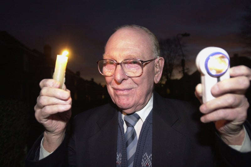 Les Seaton, 81, pictured with candle and torch, outside his house on Wisewood Avenue, Sheffield when the street lights were out in February 2001