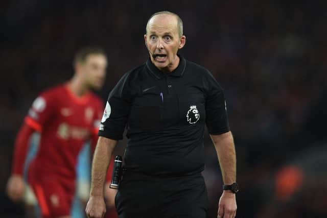 Referee Mike Dean during the game at Anfield.