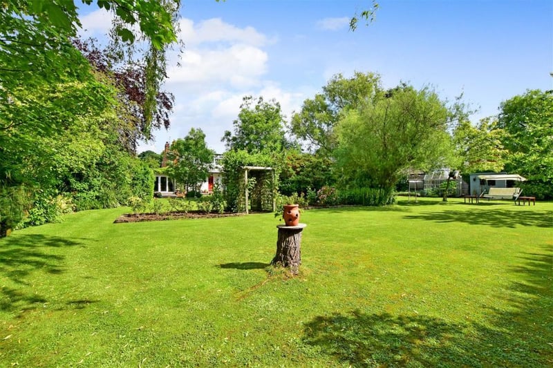 The stunning garden plot features extensive lawns