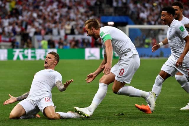 England's defender Kieran Trippier (L) celebrates with teammates after scoring a goal during the Russia 2018 World Cup semi-final football match between Croatia and England at the Luzhniki Stadium in Moscow on July 11, 2018. (Photo by Alexander NEMENOV / AFP)