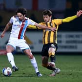 Alex Gilliead of Scunthorpe United is challenged by Jack Iredale during the Sky Bet League Two match between Cambridge United and Scunthorpe United