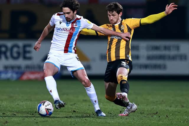 Alex Gilliead of Scunthorpe United is challenged by Jack Iredale during the Sky Bet League Two match between Cambridge United and Scunthorpe United