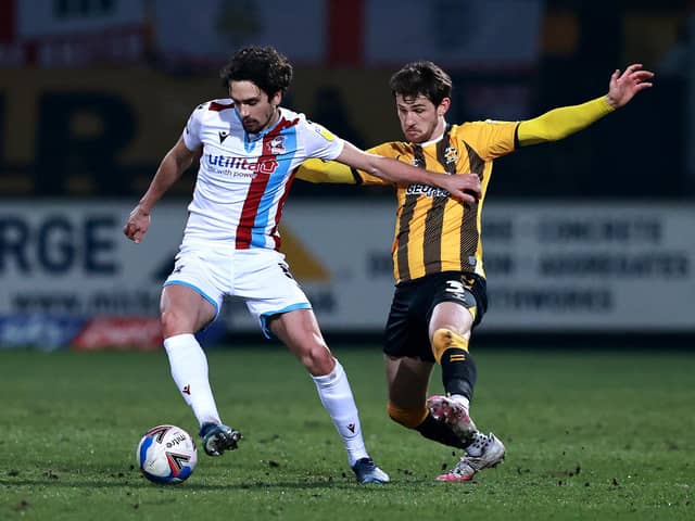 Alex Gilliead of Scunthorpe United is challenged by Jack Iredale during the Sky Bet League Two match between Cambridge United and Scunthorpe United