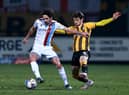 Alex Gilliead of Scunthorpe United is challenged by Jack Iredale during the Sky Bet League Two match between Cambridge United and Scunthorpe United