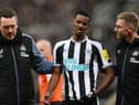 Newcastle United's Alexander Isak leaves the pitch after taking the ball to the head.