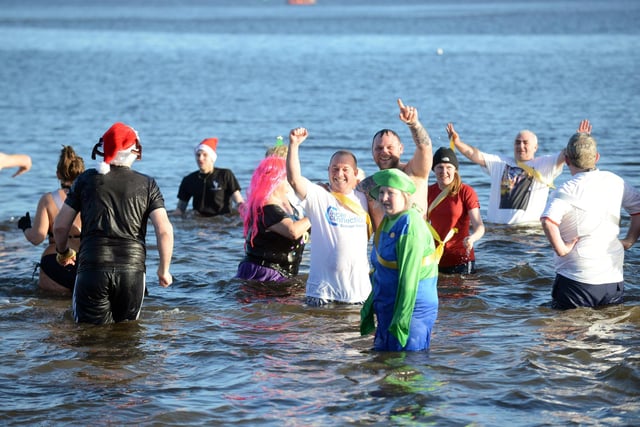 Fundraisers take part in the annual Cancer Connections Boxing Day dip at Littlehaven Beach