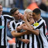 Newcastle United's Bruno Guimaraes celebrates with team-mates after scoring his second goal.