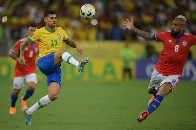 Brazil's Bruno Guimaraes (L) and Chile's Arturo Vidal vie for the ball during their South American qualification football match for the FIFA World Cup Qatar 2022 at Maracana Stadium in Rio de Janeiro, Brazil, on March 24, 2022. (Photo by CARL DE SOUZA / AFP) (Photo by CARL DE SOUZA/AFP via Getty Images)