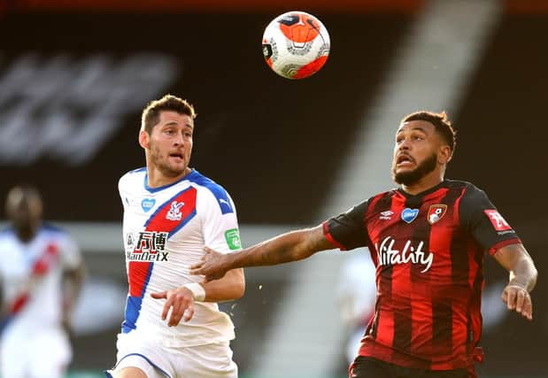 Joshua King of AFC Bournemouth battles for possession with Joel Ward of Crystal Palace.