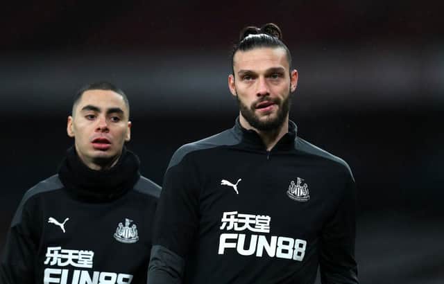 LONDON, ENGLAND - JANUARY 18: Andy Carroll of Newcastle United (R) and Miguel Almiron of Newcastle United look on during their warm up prior to the Premier League match between Arsenal and Newcastle United at Emirates Stadium on January 18, 2021 in London, England. Sporting stadiums around England remain under strict restrictions due to the Coronavirus Pandemic as Government social distancing laws prohibit fans inside venues resulting in games being played behind closed doors. (Photo by Catherine Ivill/Getty Images)