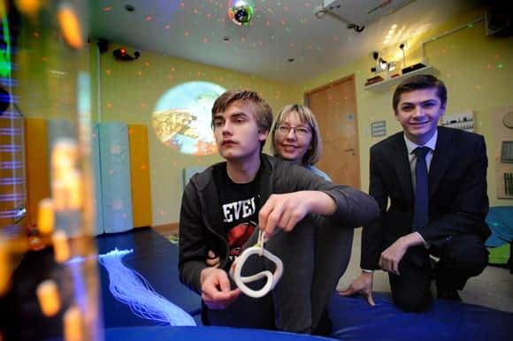 Daniel and his mam Alison are pictured in the sensory room with Cllr Adam Ellison.