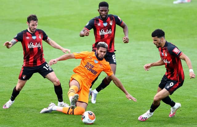 BOURNEMOUTH, ENGLAND - JULY 01: Joelinton of Newcastle United is surrounded by Adam Smith (l), Jefferson Lerma and Dominic Solanke (r) of Bournemouth during the Premier League match between AFC Bournemouth and Newcastle United at Vitality Stadium on July 01, 2020 in Bournemouth, England. (Photo by Michael Steele/Getty Images)