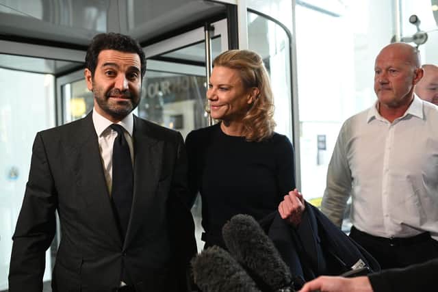 Newcastle United's new director Amanda Staveley (C) and husband Mehrdad Ghodoussi (L) talk to the media as she leaves the foyer of St James' Park in Newcastle upon Tyne in northeast England on October 8, 2021, after the sale of the football club to a Saudi-led consortium was confirmed the previous day. - (Photo by Oli SCARFF / AFP) (Photo by OLI SCARFF/AFP via Getty Images)