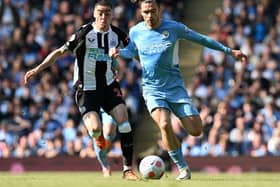 Newcastle United's Paraguayan midfielder Miguel Almiron (L) vies with Manchester City's English midfielder Jack Grealish during the English Premier League football match between Manchester City and Newcastle United at the Etihad Stadium in Manchester, north west England, on May 8, 2022 (Photo by PAUL ELLIS/AFP via Getty Images)