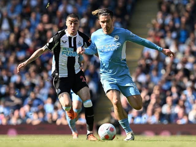Newcastle United's Paraguayan midfielder Miguel Almiron (L) vies with Manchester City's English midfielder Jack Grealish during the English Premier League football match between Manchester City and Newcastle United at the Etihad Stadium in Manchester, north west England, on May 8, 2022 (Photo by PAUL ELLIS/AFP via Getty Images)