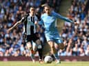 Newcastle United's Paraguayan midfielder Miguel Almiron (L) vies with Manchester City's English midfielder Jack Grealish during the English Premier League football match between Manchester City and Newcastle United at the Etihad Stadium in Manchester, north west England, on May 8, 2022 (Photo by PAUL ELLIS/AFP via Getty Images)