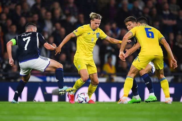Ukraine's midfielder Mykhaylo Mudryk (C) fights for the ball with Scotland's midfielder John McGinn (L) during the UEFA Nations League B Group 1 football match at Hampden Park stadium, in Glasgow, on September 21, 2022. (Photo by ANDY BUCHANAN / AFP) (Photo by ANDY BUCHANAN/AFP via Getty Images)