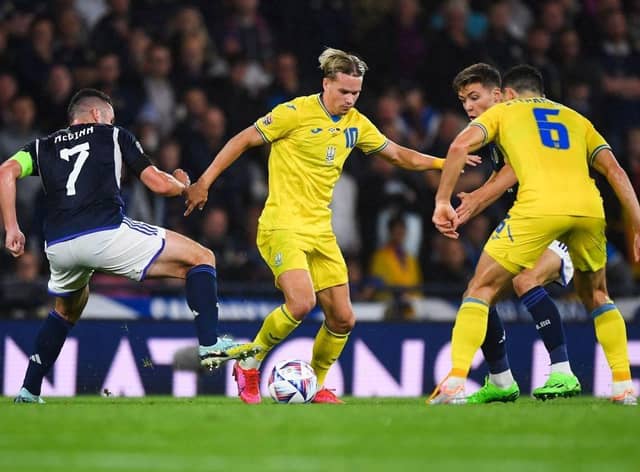 Ukraine's midfielder Mykhaylo Mudryk (C) fights for the ball with Scotland's midfielder John McGinn (L) during the UEFA Nations League B Group 1 football match at Hampden Park stadium, in Glasgow, on September 21, 2022. (Photo by ANDY BUCHANAN / AFP) (Photo by ANDY BUCHANAN/AFP via Getty Images)