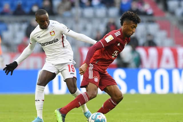 Bayern Munich's French midfielder Kingsley Coman (R) and Leverkusen's French striker Moussa Diaby vie for the ball.