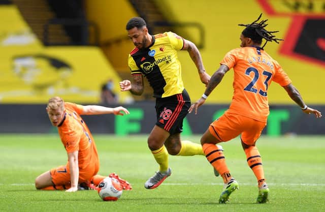 WATFORD, ENGLAND - JULY 11: Andre Gray of Watford takes on Valentino Lazaro of Newcastle United during the Premier League match between Watford FC and Newcastle United at Vicarage Road on July 11, 2020 in Watford, England. (Photo by Justin Setterfield/Getty Images)