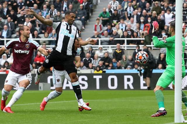 NEWCASTLE UPON TYNE, ENGLAND - AUGUST 15: Callum Wilson of Newcastle United scores their side's first goal past Lukasz Fabianski of West Ham United during the Premier League match between Newcastle United and West Ham United at St. James Park on August 15, 2021 in Newcastle upon Tyne, England. (Photo by Ian MacNicol/Getty Images)