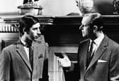 Prince Charles talking to his father, the Duke of Edinburgh, in front of a fireplace at Sandringham, Scotland, 1969. Picture: Central Press/Hulton Archive/Getty Images.