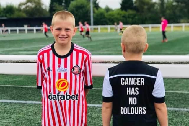 Youngsters Fin Thompson (left) and Freddie Thompson (right) showed their support at the annual football match.