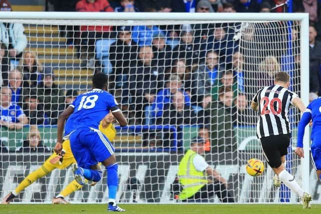 Newcastle United's New Zealand striker Chris Wood (2R) scores the opening goal from the penalty spot during the English Premier League football match between Leicester City and Newcastle United at King Power Stadium in Leicester, central England on December 26, 2022. (Photo by LINDSEY PARNABY/AFP via Getty Images)