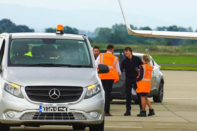 Actor Tom Cruise is greeted after touching down at Teesside International Airport.