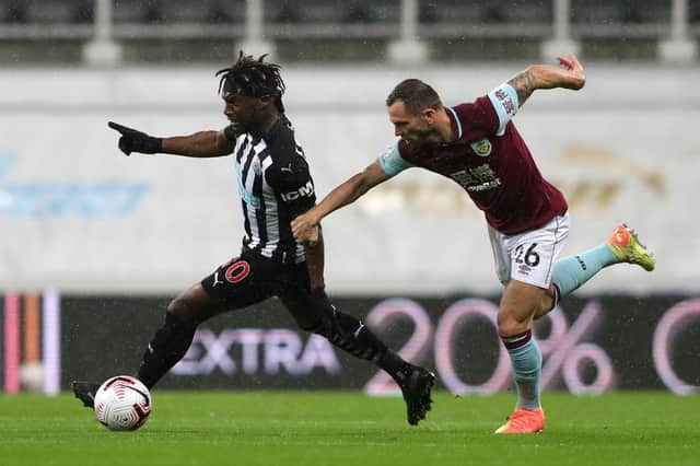 Allan Saint-Maximin of Newcastle United is challenged by Phil Bardsley of Burnley.