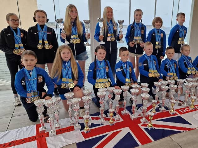 Members of the Dokan karate squad with their world championship trophy haul.