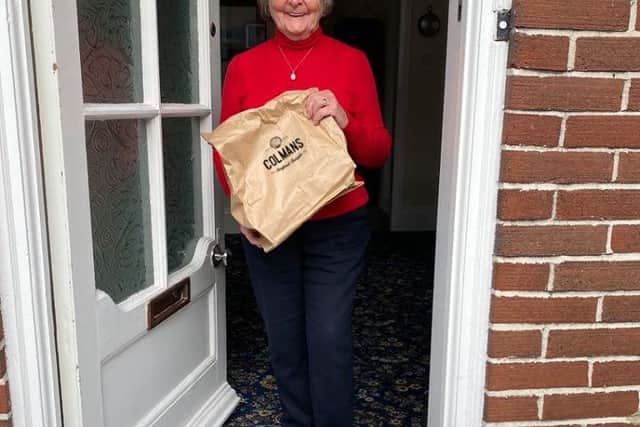One happy customer with her home delivery of Colmans fish and chips. Photo by Colmans.