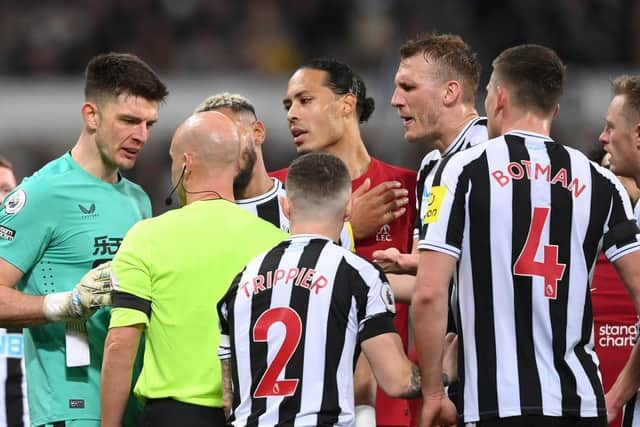 NEWCASTLE UPON TYNE, ENGLAND - FEBRUARY 18: Referee Anthony Taylor talks with goalkeeper Nick Pope of Newcastle United after sending him off for handling the ball outside the box during the Premier League match between Newcastle United and Liverpool FC at St. James Park on February 18, 2023 in Newcastle upon Tyne, England. (Photo by Stu Forster/Getty Images)