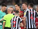 NEWCASTLE UPON TYNE, ENGLAND - FEBRUARY 18: Referee Anthony Taylor talks with goalkeeper Nick Pope of Newcastle United after sending him off for handling the ball outside the box during the Premier League match between Newcastle United and Liverpool FC at St. James Park on February 18, 2023 in Newcastle upon Tyne, England. (Photo by Stu Forster/Getty Images)