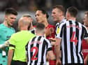 NEWCASTLE UPON TYNE, ENGLAND - FEBRUARY 18: Referee Anthony Taylor talks with goalkeeper Nick Pope of Newcastle United after sending him off for handling the ball outside the box during the Premier League match between Newcastle United and Liverpool FC at St. James Park on February 18, 2023 in Newcastle upon Tyne, England. (Photo by Stu Forster/Getty Images)