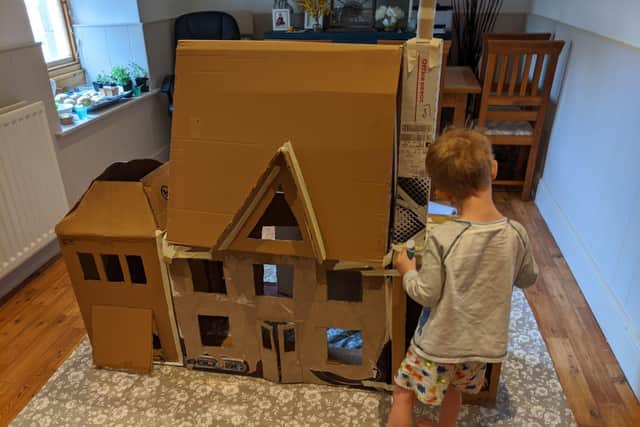 A cardboard house in progress.