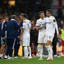 Leeds United's Pascal Struijk, right, is consoled by Liam Cooper after being shown a red card.