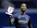 Ivan Toney holds up a man of the match award.