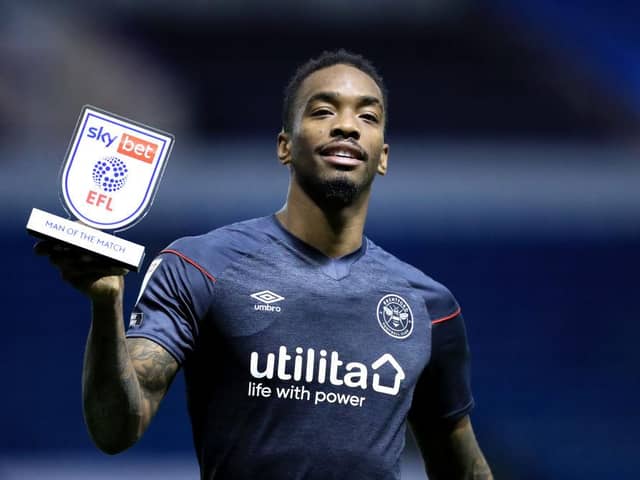 Ivan Toney holds up a man of the match award.