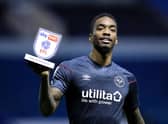Ivan Toney holds up a man of the match award.