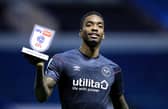 Ivan Toney holds up a man of the match award.