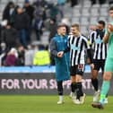 Kieran Trippier, Matt Targett and Jamaal Lascelles of Newcastle United share a joke after the friendly match between Newcastle United and Rayo Vallecano at St James' Park on December 17, 2022 in Newcastle upon Tyne, England. (Photo by Stu Forster/Getty Images)