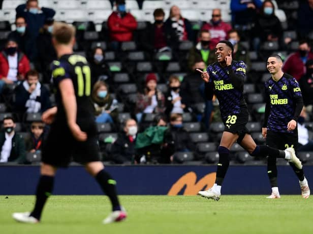 Joe Willock of Newcastle United celebrates after scoring the opening goal during the Premier League match between Fulham and Newcastle United at Craven Cottage on May 23, 2021 in London, England.