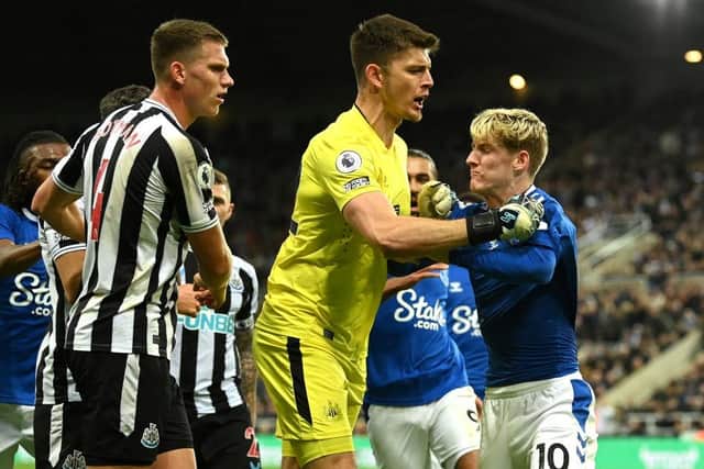 Nick Pope of Newcastle United steps in as tempers flare between the Newcastle United defence and Anthony Gordon of Everton during the Premier League match between Newcastle United and Everton FC at St. James Park on October 19, 2022 in Newcastle upon Tyne, England. (Photo by Stu Forster/Getty Images)