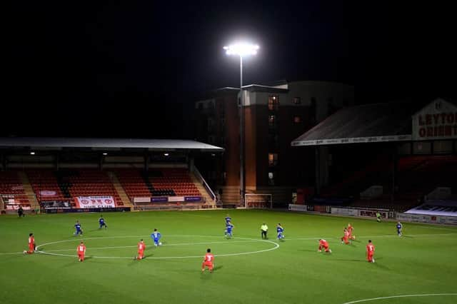 Players from both sides take a knee for the Black Lives Matter movement prior to the EFL Trophy match between Leyton Orient and AFC Wimbledon.